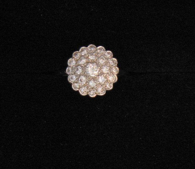 Appraisal: A DIAMOND CLUSTER RING of circular design pave-set overall with