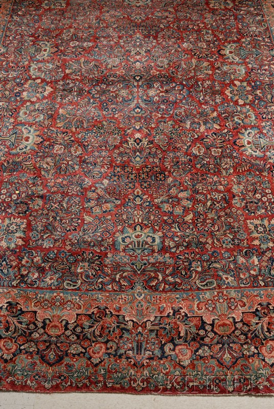 Appraisal: Sarouk Carpet with medium red ground and overall design of