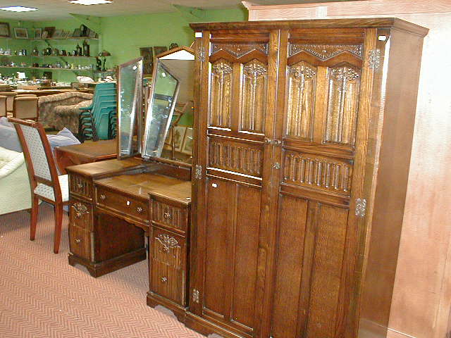 Appraisal: A reproduction linen fold two door wardrobe and dressing table