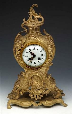 Appraisal: A FRENCH ROCOCO MANTEL CLOCK having a circular white enamel