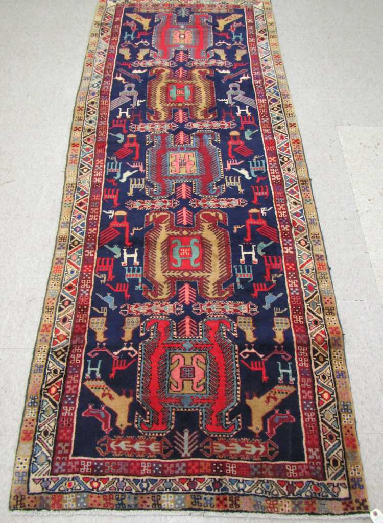 Appraisal: SEMI-ANTIQUE PERSIAN TRIBAL HALL RUG five geometric medallion and stylized