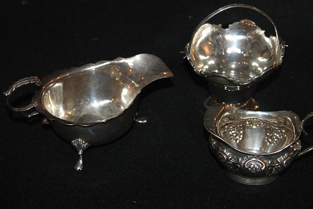 Appraisal: A GEORGIAN STYLE SILVER SAUCE BOAT with flying loop handle