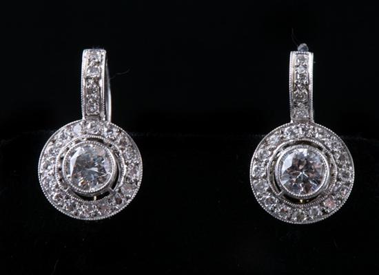 Appraisal: PAIR K WHITE GOLD AND DIAMOND EARRINGS Each centers bezel-held