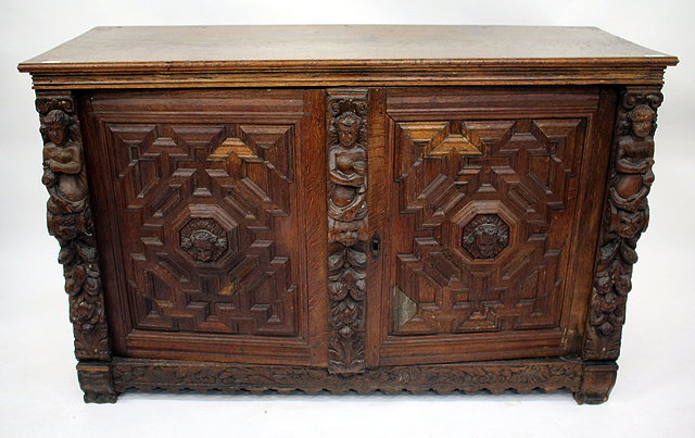 Appraisal: AN ANTIQUE FRENCH SIDE CABINET with mitred panelled doors carved