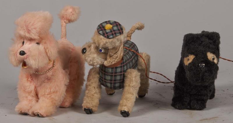 Appraisal: Lot Of Alps Wind-Up Toy Dogs Including a pink poodle