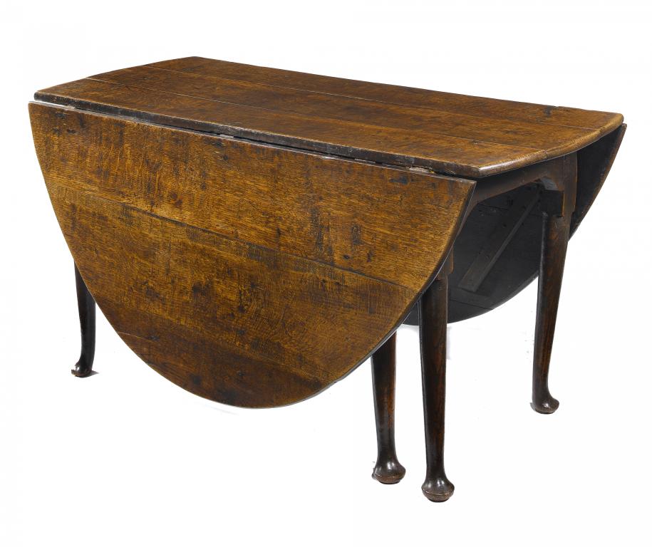 Appraisal: A GEORGE II OAK GATE-LEG TABLE the boarded oval top