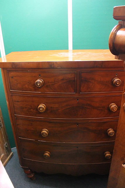 Appraisal: A VICTORIAN MAHOGANY BOW FRONT CHEST of two short and