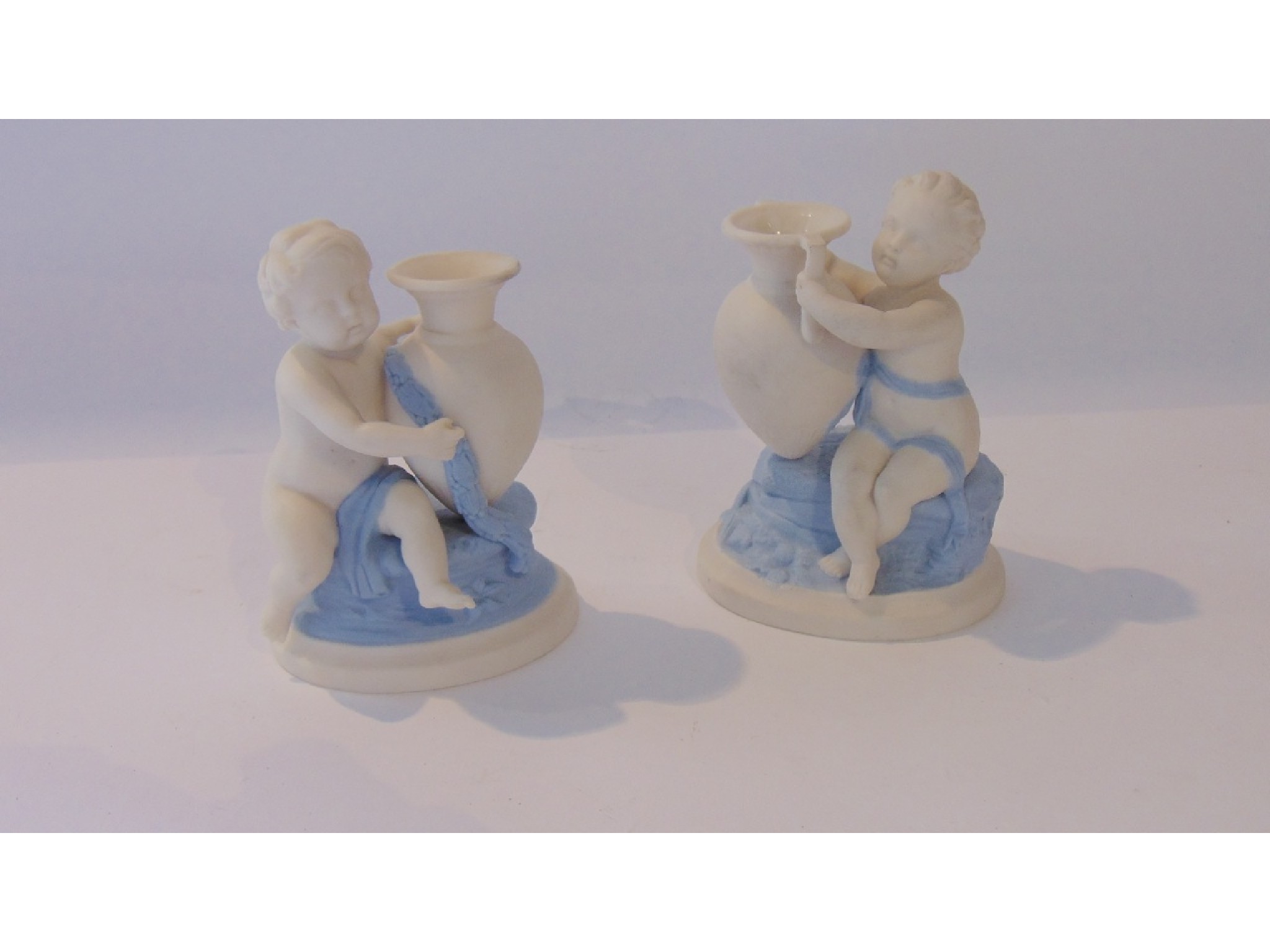 Appraisal: A pair of Victorian Worcester parian type candle holders in