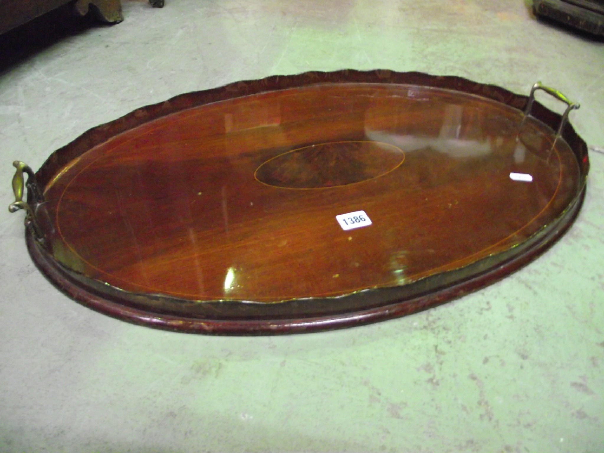 Appraisal: An Edwardian mahogany tea tray of oval form with boxwood