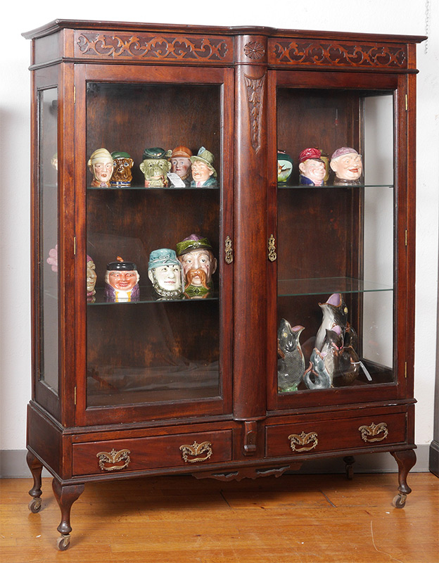 Appraisal: MAHOGANY CARVED BOOKCASE ON STAND Top and front with bowed