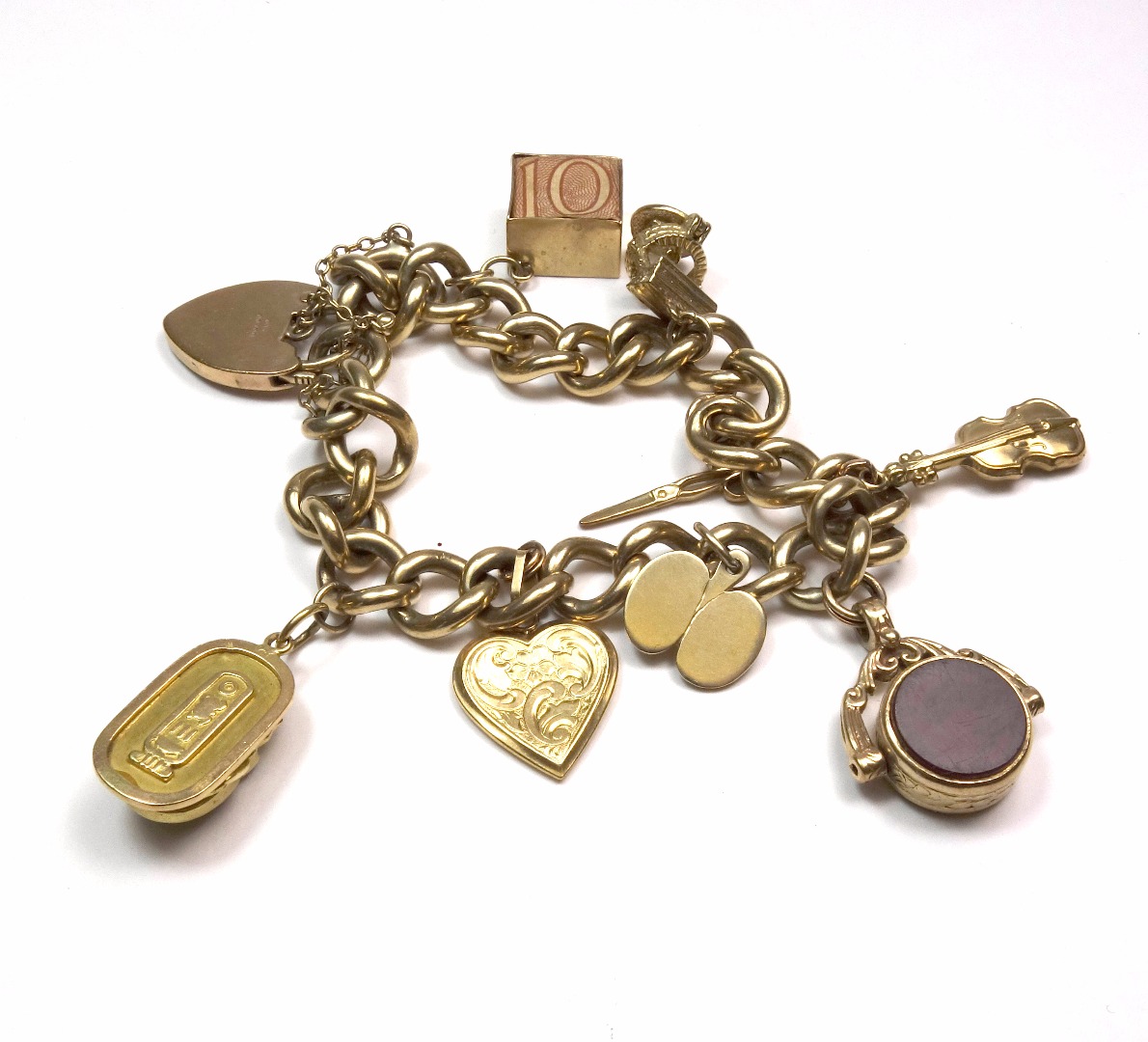 Appraisal: A ct gold curb-link 'charm' bracelet on a foliate engraved