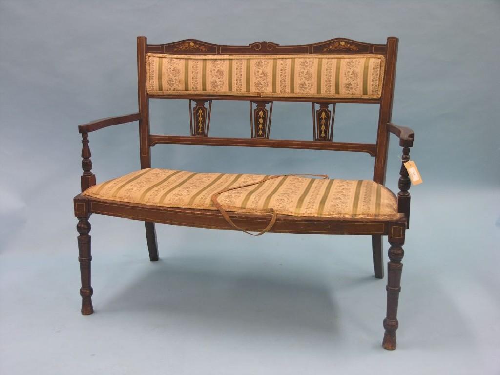 Appraisal: An Edwardian inlaid mahogany settee two-seater triple splat-back front turned