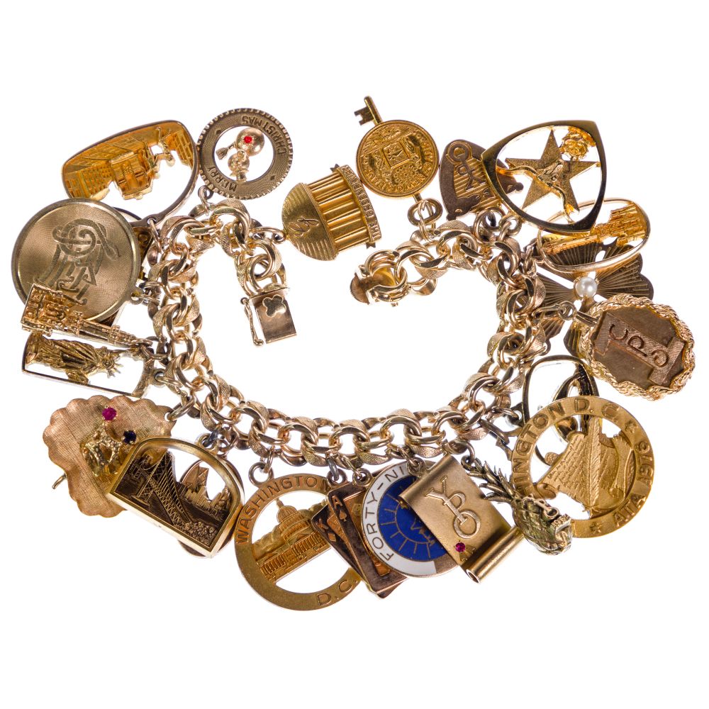 Appraisal: GOLD CHARM BRACELETIncluding charms in k a bracelet and charms