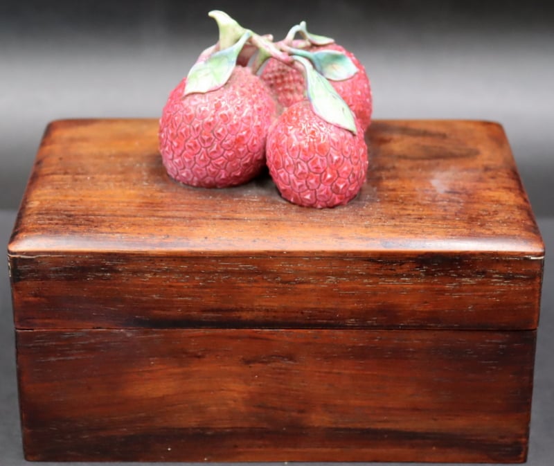 Appraisal: ASIAN WOODEN BOX WITH APPLIED PORCELAIN LYCHEE Asian wooden lidded