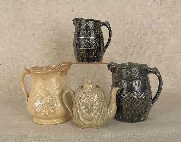 Appraisal: Three pottery pitchers two with hawk form spouts together with