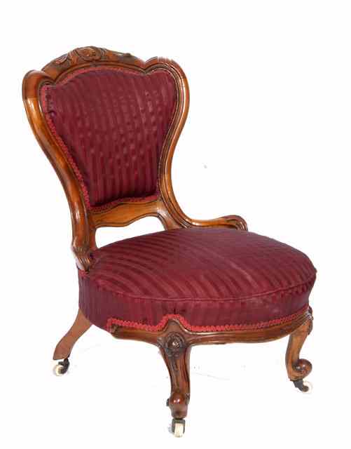 Appraisal: A VICTORIAN WALNUT AND UPHOLSTERED NURSING CHAIR the cartouche shaped