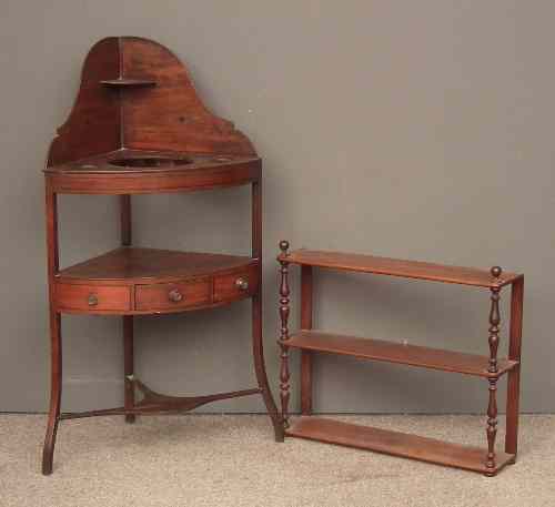 Appraisal: A George III mahogany three tier corner washstand with bow