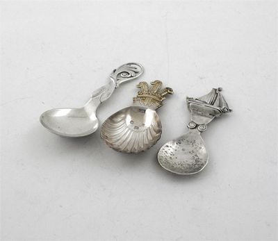 Appraisal: Three modern caddy spoons a Danish example with an openwork