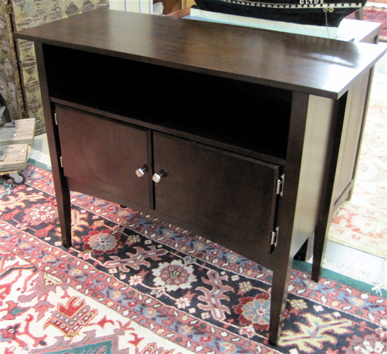 Appraisal: DARK MAHOGANY SERVING STAND contemporary having a rectangular top overhanging