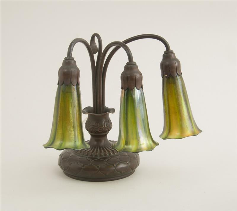 Appraisal: TIFFANY STUDIOS BRONZE THREE-LIGHT DESK LAMP WITH A FAVRILE GLASS