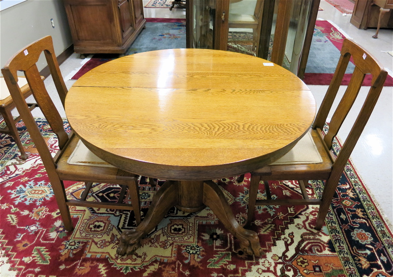 Appraisal: ROUND OAK DINING TABLE FOUR CHAIRS AND TWO LEAVES American