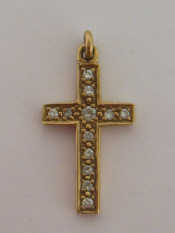 Appraisal: A yellow metal tests as carat gold and diamond cross