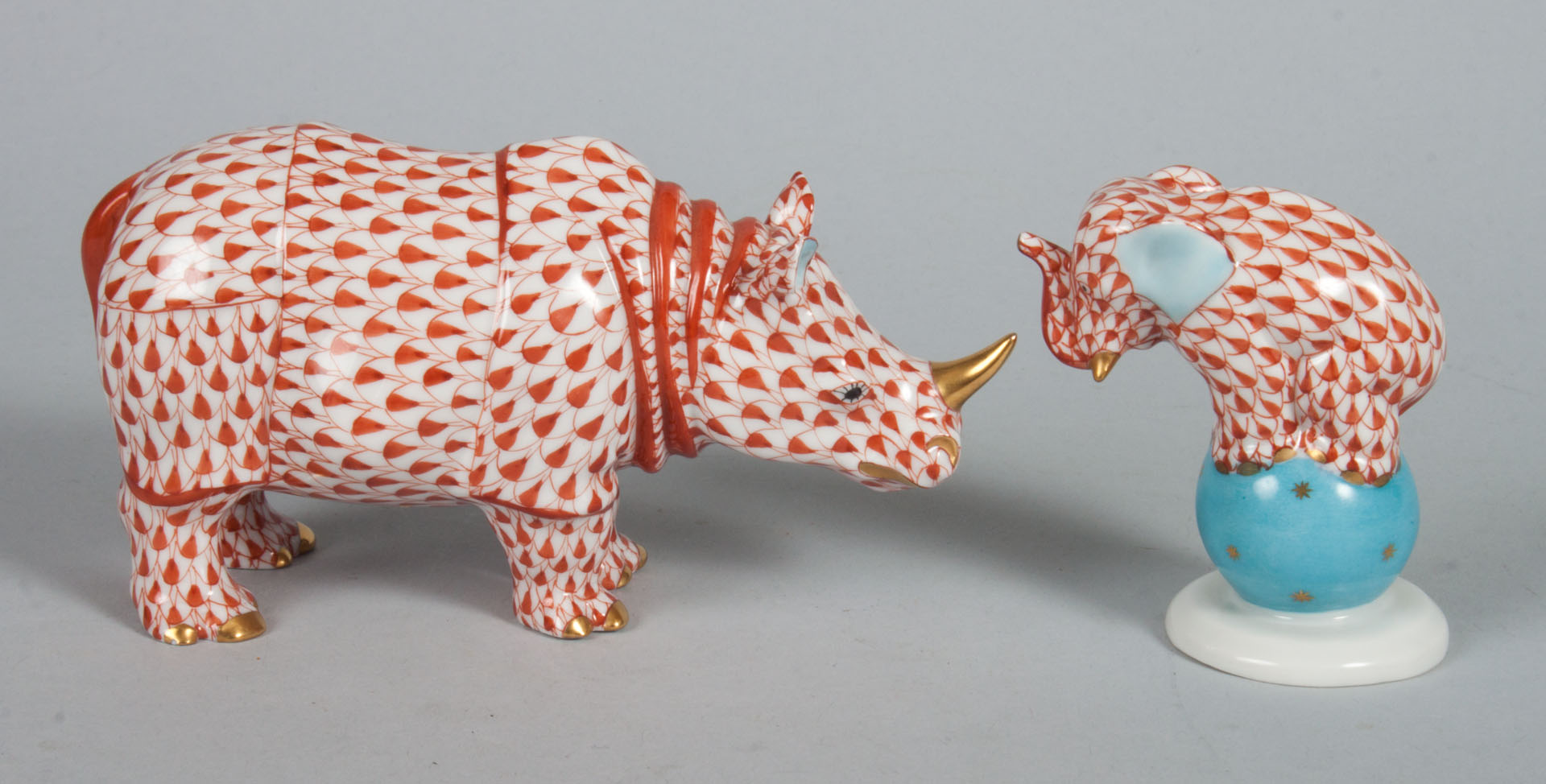 Appraisal: Herend porcelain rhinoceros and an elephant in the Rust Fishnet