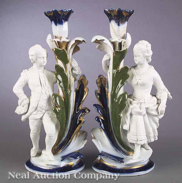 Appraisal: A Pair of French Porcelain and Biscuit Figural Candlesticks mid-