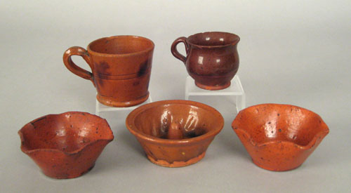 Appraisal: Pennsylvania miniature redware to include a mold two handled cups