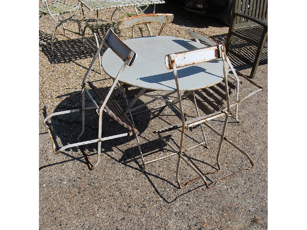 Appraisal: Painted metal circular terrace table and four folding chairs with