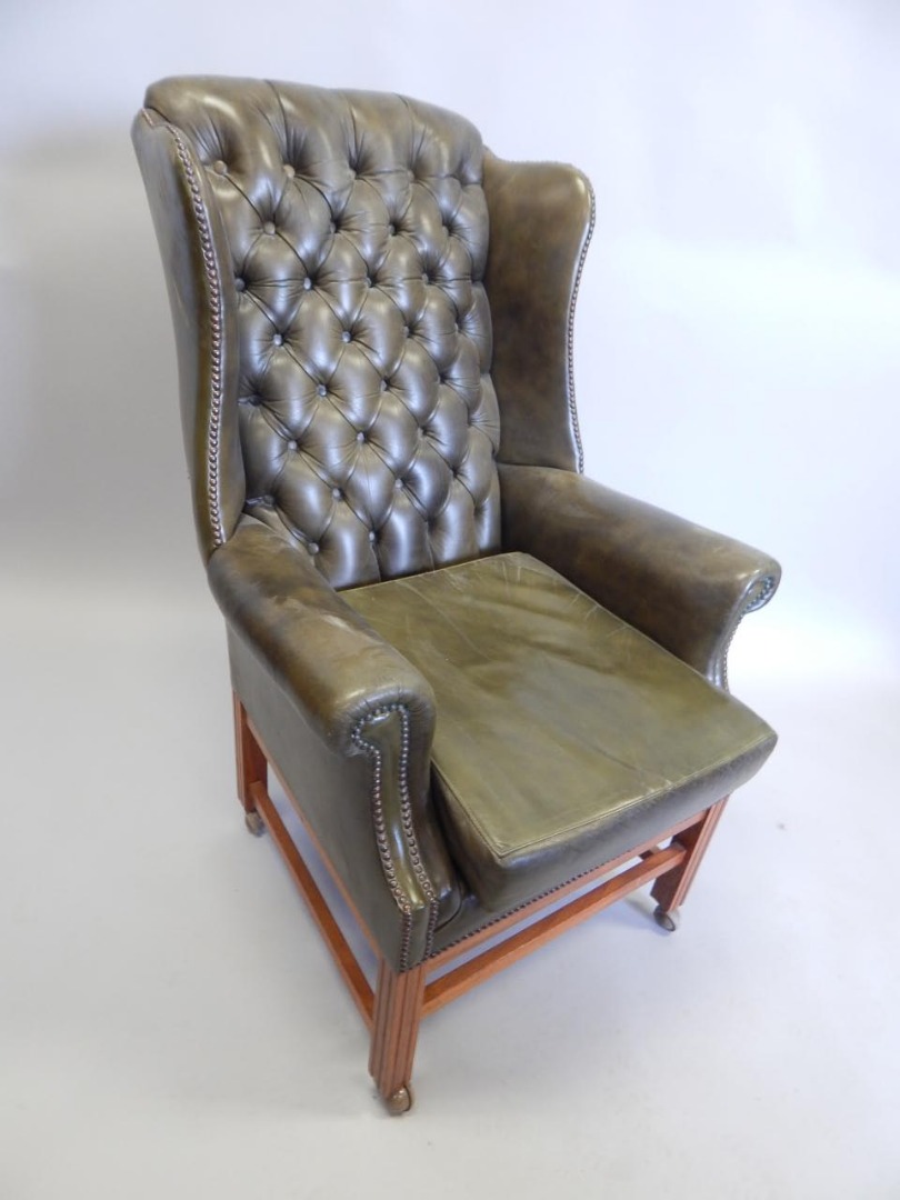 Appraisal: A George III style vintage green leather wingback chair on