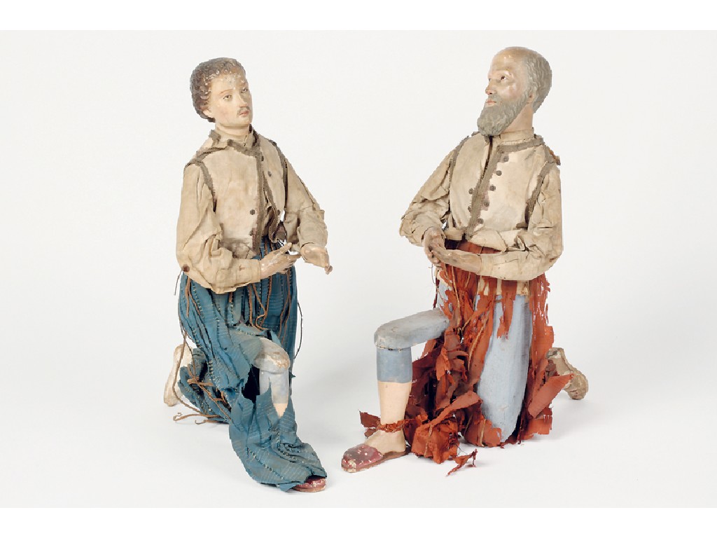 Appraisal: A PAIR OF CARVED AND NATURALISTICALLY PAINTED KNEELING FIGURES each