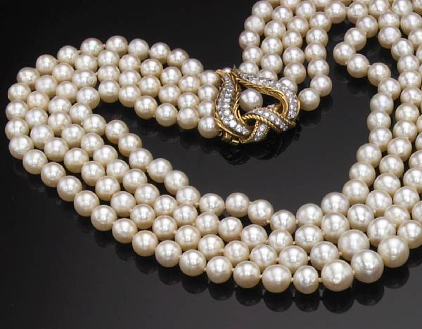 Appraisal: A four strand cultured pearl necklace with diamond and gold