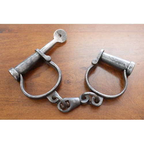 Appraisal: Pair of antique iron manacles with key ex Armidale Family