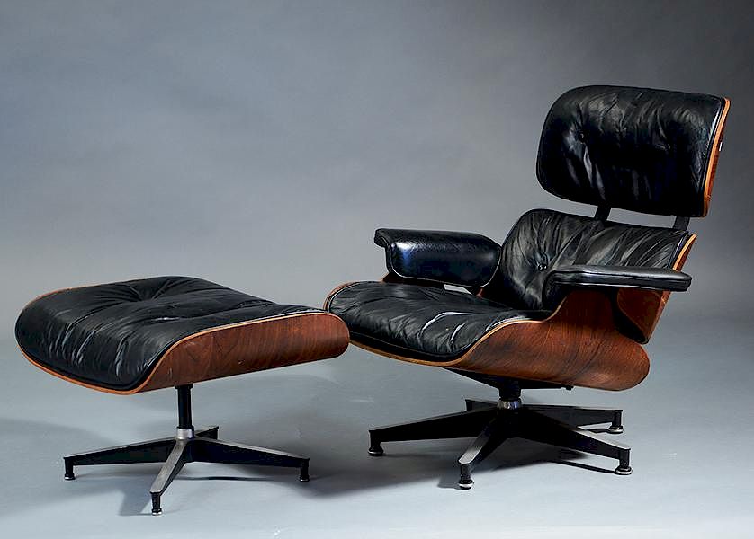 Appraisal: Herman Miller black leather and rosewood chair and ottoman Herman