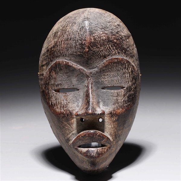 Appraisal: Carved wooden mask in the style of the Dan people