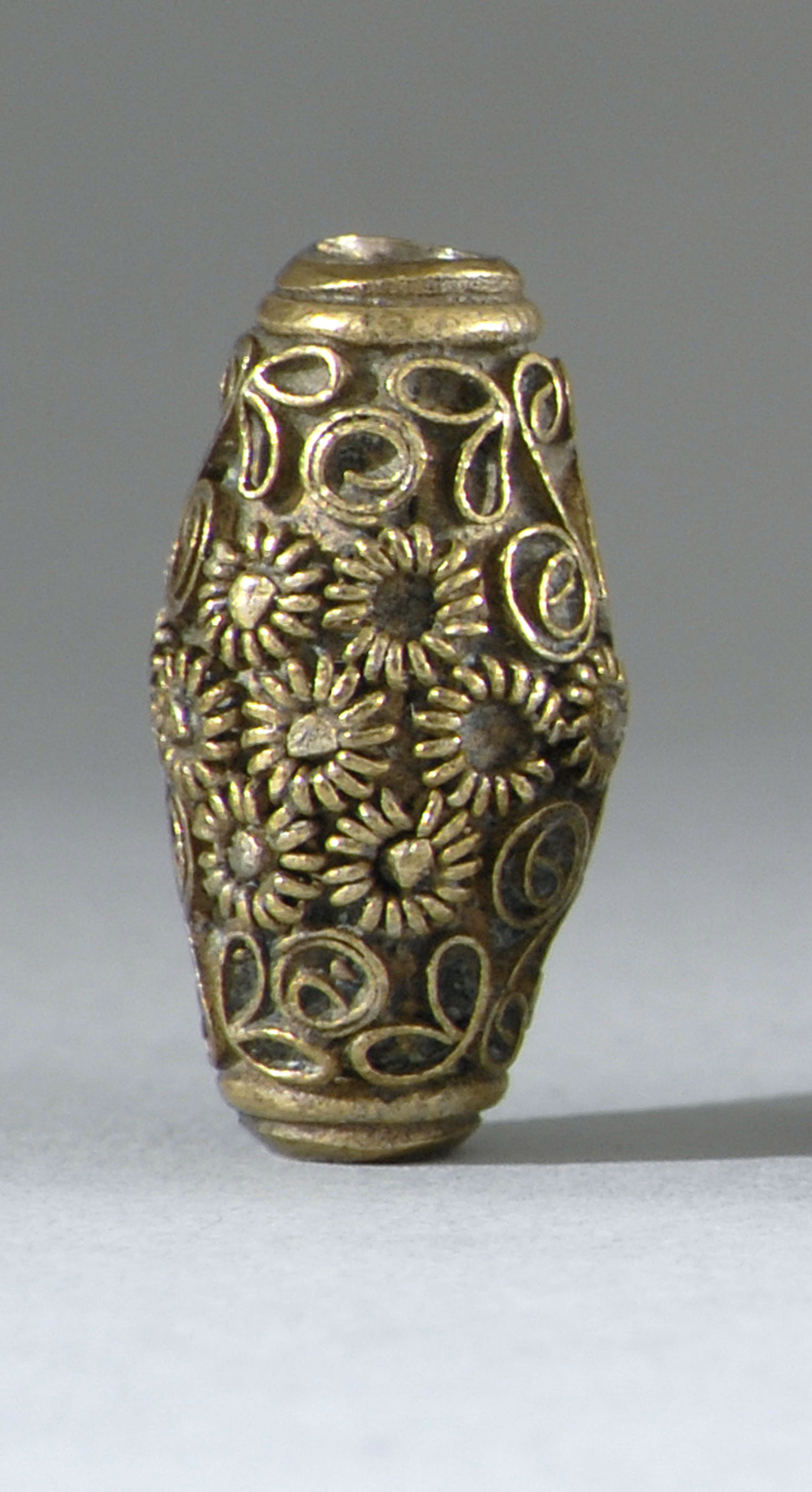 Appraisal: BRASS OJIME th CenturyIn seed form with floral design Length