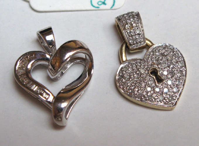 Appraisal: TWO DIAMOND AND FOURTEEN KARAT GOLD HEART PENDANTS one set