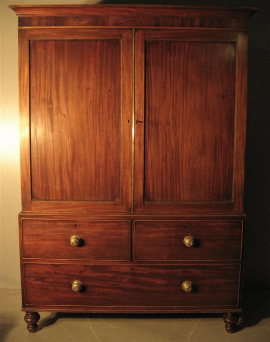 Appraisal: th century mahogany linen press with two cupboard doors over