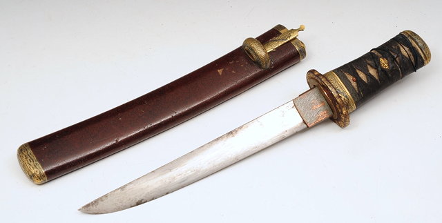 Appraisal: A JAPANESE LADY'S DAGGER in a leather scabbard with Shakudo