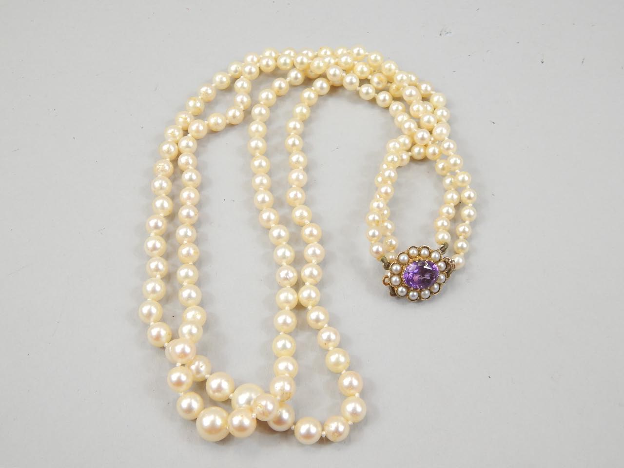 Appraisal: A double row simulated pearl necklace with clasp stamped set