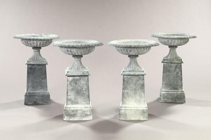 Appraisal: Set of Four Neoclassical-Style Cast-Iron Garden Urns-on-Stands in three sections