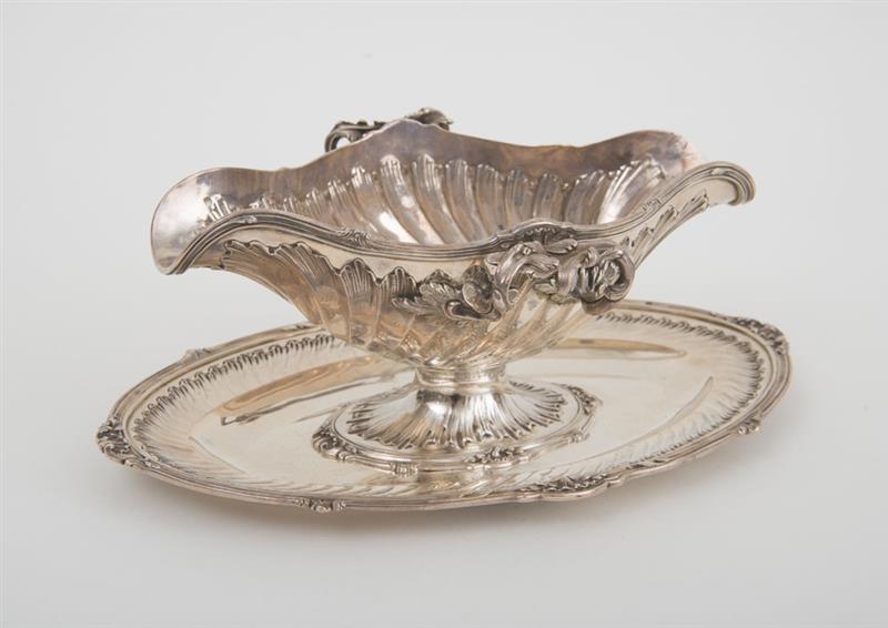 Appraisal: FRENCH SILVER DOUBLE SPOUTED SAUCE BOAT AND ATTACHED STAND IN