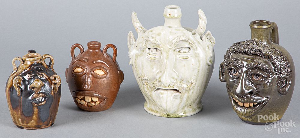 Appraisal: Four southern pottery face jugs Four southern pottery face jugs