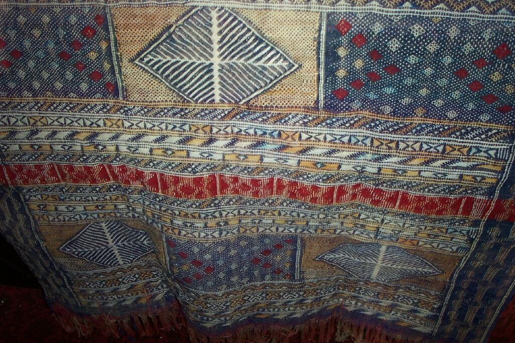 Appraisal: A blue ground woven hanging with geometric decoration in red