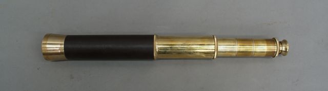 Appraisal: A small brass telescope with leather covered body