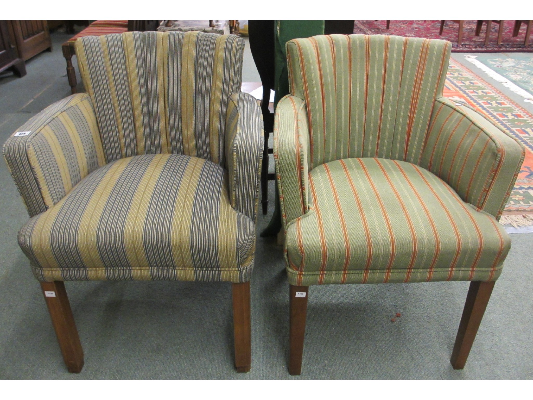 Appraisal: A pair of upholstered ships armchairs