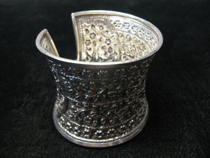 Appraisal: Large sterling cuff Wide hourglass shaped sterling cuff with floral