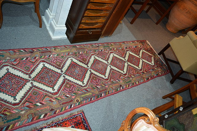 Appraisal: Hamadan wool runnerwith central geometric medallions within a coloured border