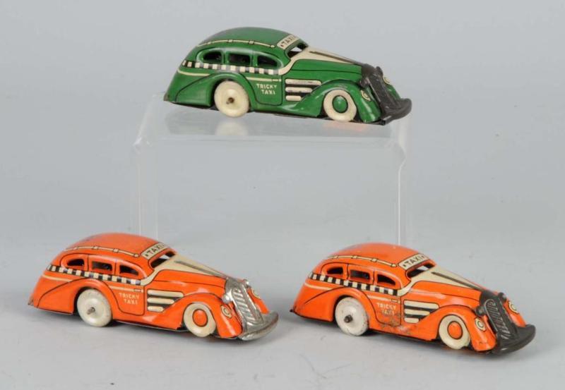 Appraisal: Lot of Tin Litho Marx Tricky Taxi Toys Description American